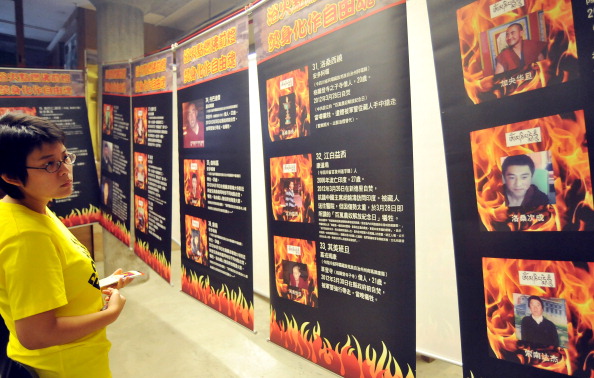 A woman looks at an exhibition showing p Epoch Times Photo