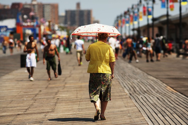 Coney Island Development Plan To Change Landscape Of Historic Amusement Park A woman walks down the boardwalk in Coney Island on July 12, 2012 in the Brooklyn borough of New York City. (Spencer Platt/Getty Images)