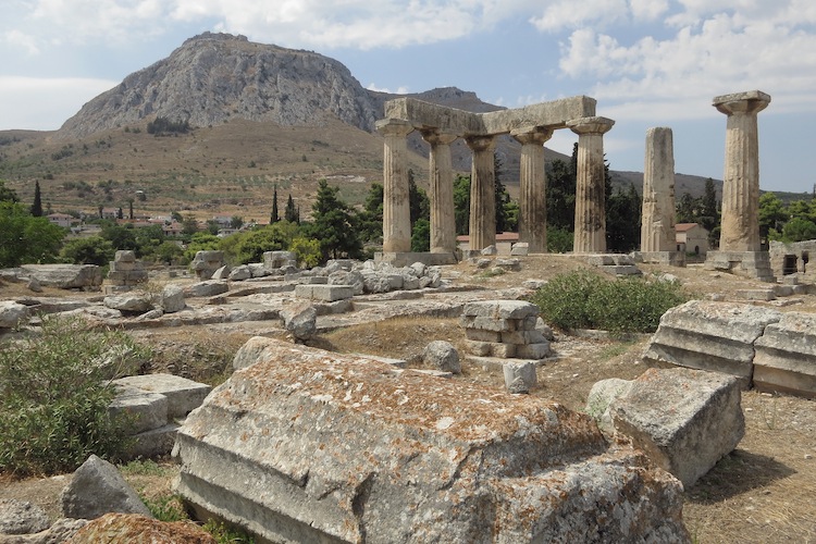 Columns of the former Temple of Apollo stand at the archeological site of Corinth with the ancient fortification of Corinth on a hilltop nearby on August 1, 2012. (Sean Gallup/Getty Images) Columns of the former Temple of Apollo stand at the archeological site of Corinth with the ancient fortification of Corinth on a hilltop nearby on August 1, 2012. (Sean Gallup/Getty Images)