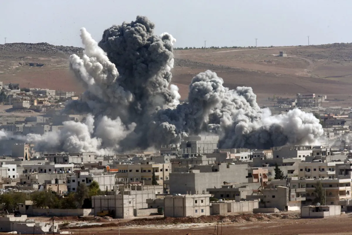 Smoke from an airstrike by the U.S.-led coalition in Kobani, Syria, on Oct. 22, 2014. (AP Photo/Lefteris Pitarakis)