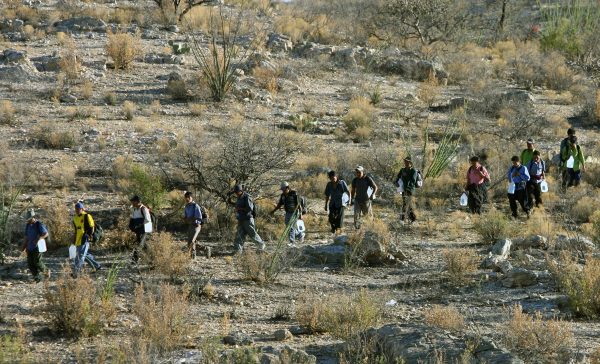 Mexican immigrants walk in line through the Arizona desert near Sasabe, Sonora State, in an attempt to illegally cross the U.S.-Mexico border, on April 6, 2006. (Omar Torres/AFP/Getty Images)