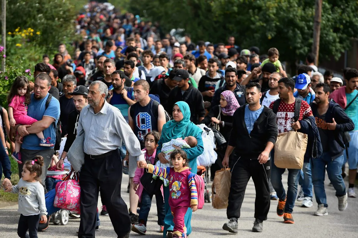 Hundreds of migrants arrive off a train from Roszke, at Hegyshalom Railway Station on the Austrian border, after Hungarian authorities closed the open railway track crossing in Hegyeshalom, Hungary, on Sept. 15, 2015. (Jeff J. Mitchell/Getty Images)