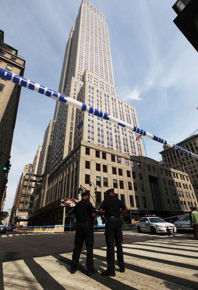 11 Shot, Two Killed, In Shooting By NYC's Empire State Building New York City police officers stand near the scene of a shooting near the Empire State Building on Friday, August 24 where Jeffrey Johnson shot and killed Steven Ercolino before police killed Ercolino. Nine bystanders were wounded in the incident, all from police bullets. (Mario Tama/Getty Images)