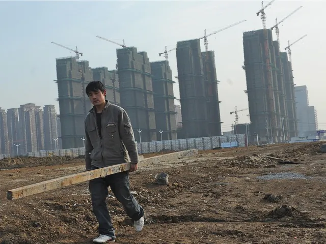 A laborer carries materials at the construction site of a new housing project in Hefei, in eastern China's Anhui province on Feb. 18, 2012. The real estate market, which had been booming prior to the global recession, has markedly worsened. (STR/AFP/Getty Images)