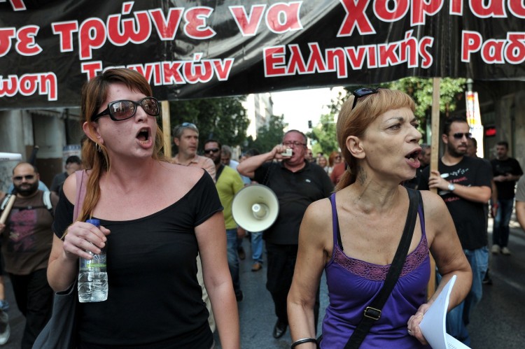 Journalists  shout as they march in central Athens during a 24-hour strike.