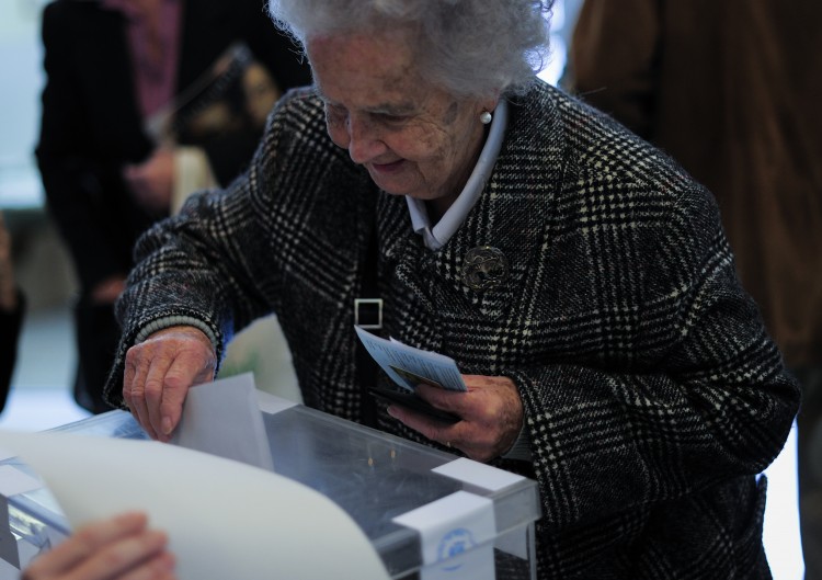 An elderly woman casts her ballot for regional elections in Barcelona on Nov. 25. (Josep Lago/AFP/Getty Images) 