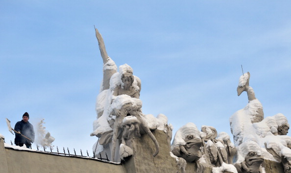 A communal worker cleans snow from sculptures adorning the roof of the "House with Chimaeras" by architect Vladislav Gorodetsky (1863-1930) in Kiev  on Dec. 17. (Sergei Supinsky/AFP/Getty Images)
