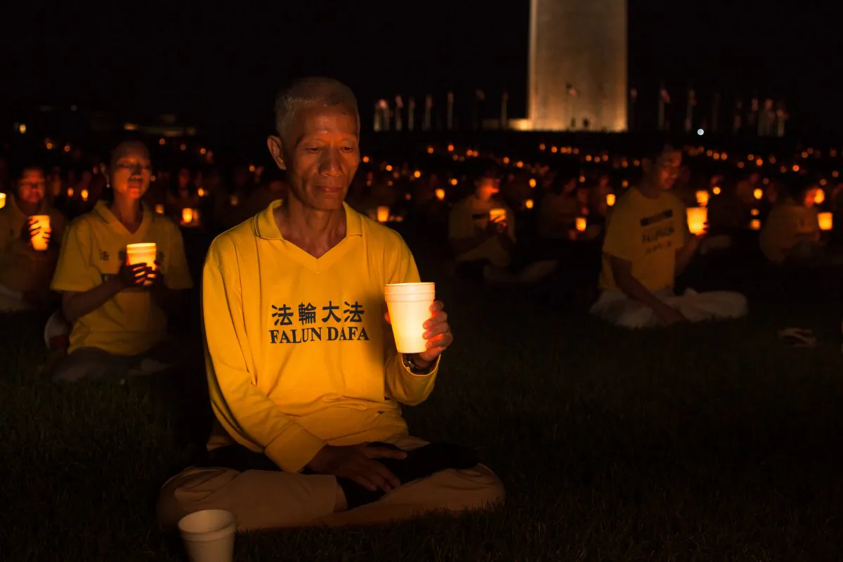 Practitioners of Falun Dafa (also Falun Gong) hold a candle light vigil by the Washington Monument on July 16, 2015, to commemorate the 16 years their fellow practitioners have been facing persecution in China. (Petr Svab/Epoch Times)