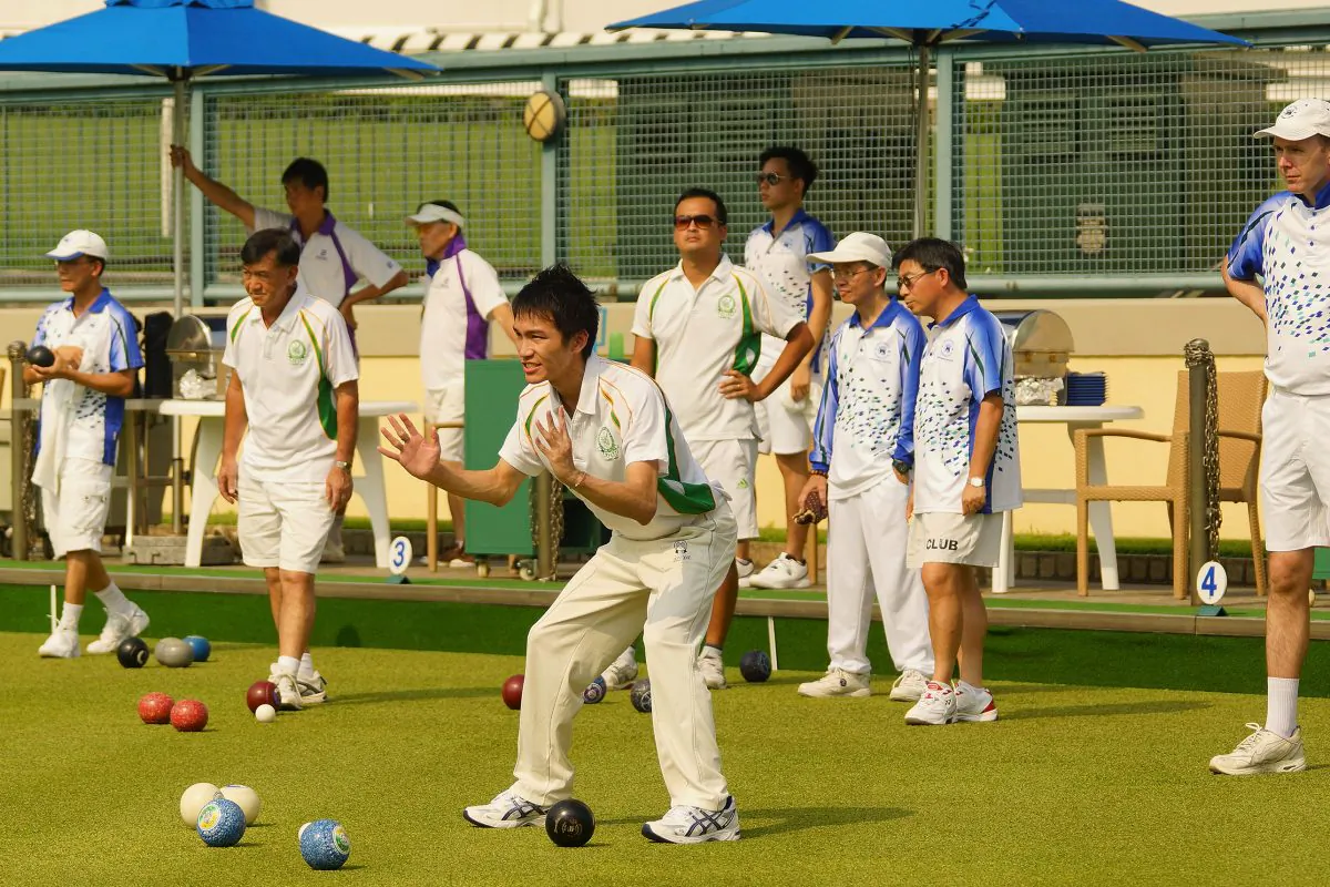 Top young bowler Lee Ka Ho indicates the distance to his Craigengower Cricket Club teammate during his league match against Hong Kong Football Club last weekend, September 12, 2015. At the end Lee lost the game 20:11 to ex-Hong Kong international SK Ng and CCC registered a 6-2 overall defeat. (Mike Worth)
