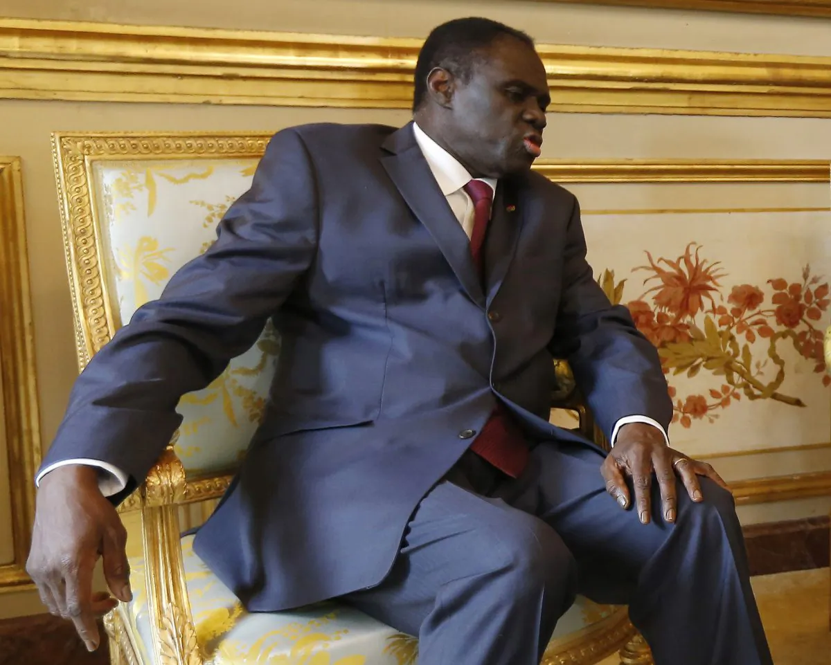In this June 1,  2015 photo, Burkina Faso's transitional president Michel Kafando meets with French president Francois Hollande at the Elysee Palace in Paris, France. (Ian Langsdon/Pool Photo via AP)