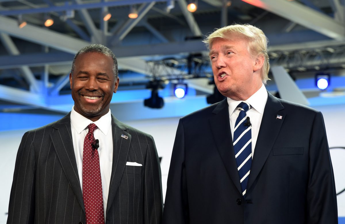 Neurosurgeon Ben Carson (L) smiles as real estate magnate Donald Trump speaks after they arrived on stage for the Republican presidential debate at the Ronald Reagan Presidential Library in Simi Valley, California on Sept. 16, 2015. (Robyn Beck/AFP/Getty Images)