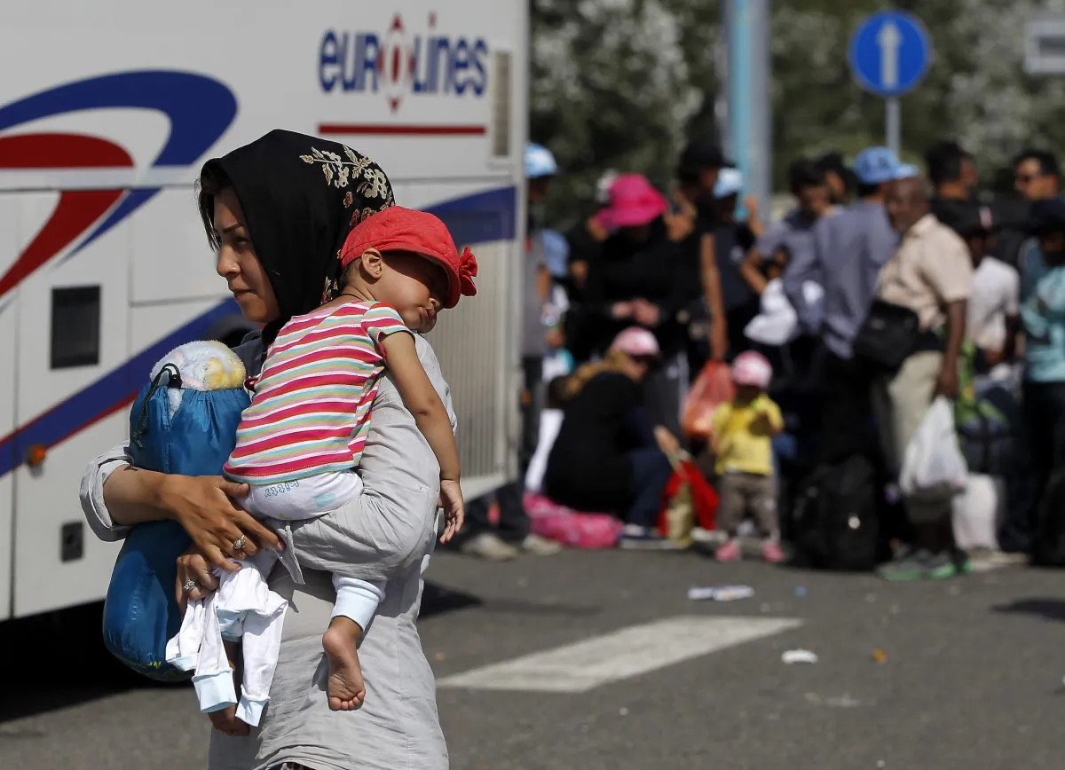 Migrants board a bus which will take them to Croatia at the Horgos border crossing with Hungary on September 17, 2015 in Horgos, Serbia. (Srdjan Stevanovic/Getty Images)