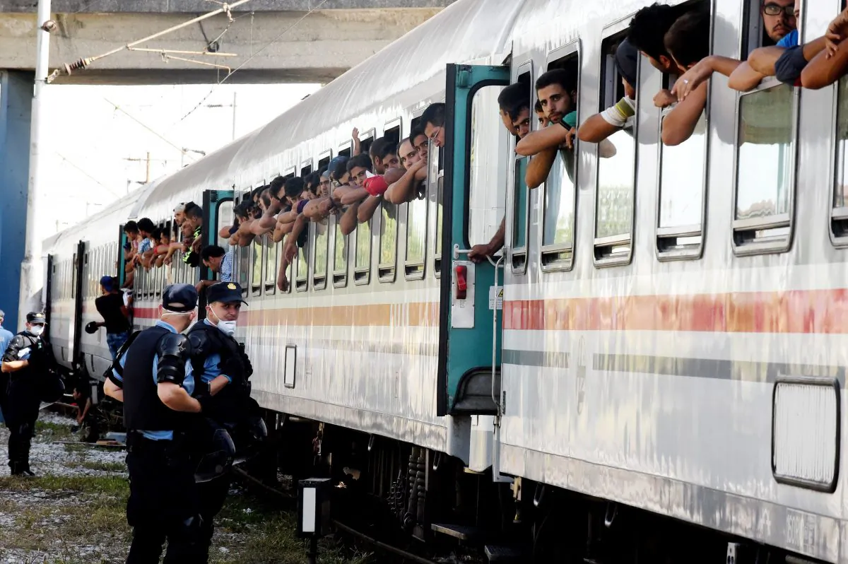 Croatian Police stand on the sidings beside a train carrying migrants and refugees in a marshalling yard near Zagreb, on Sept. 18, 2015. (STR/AFP/Getty Images)