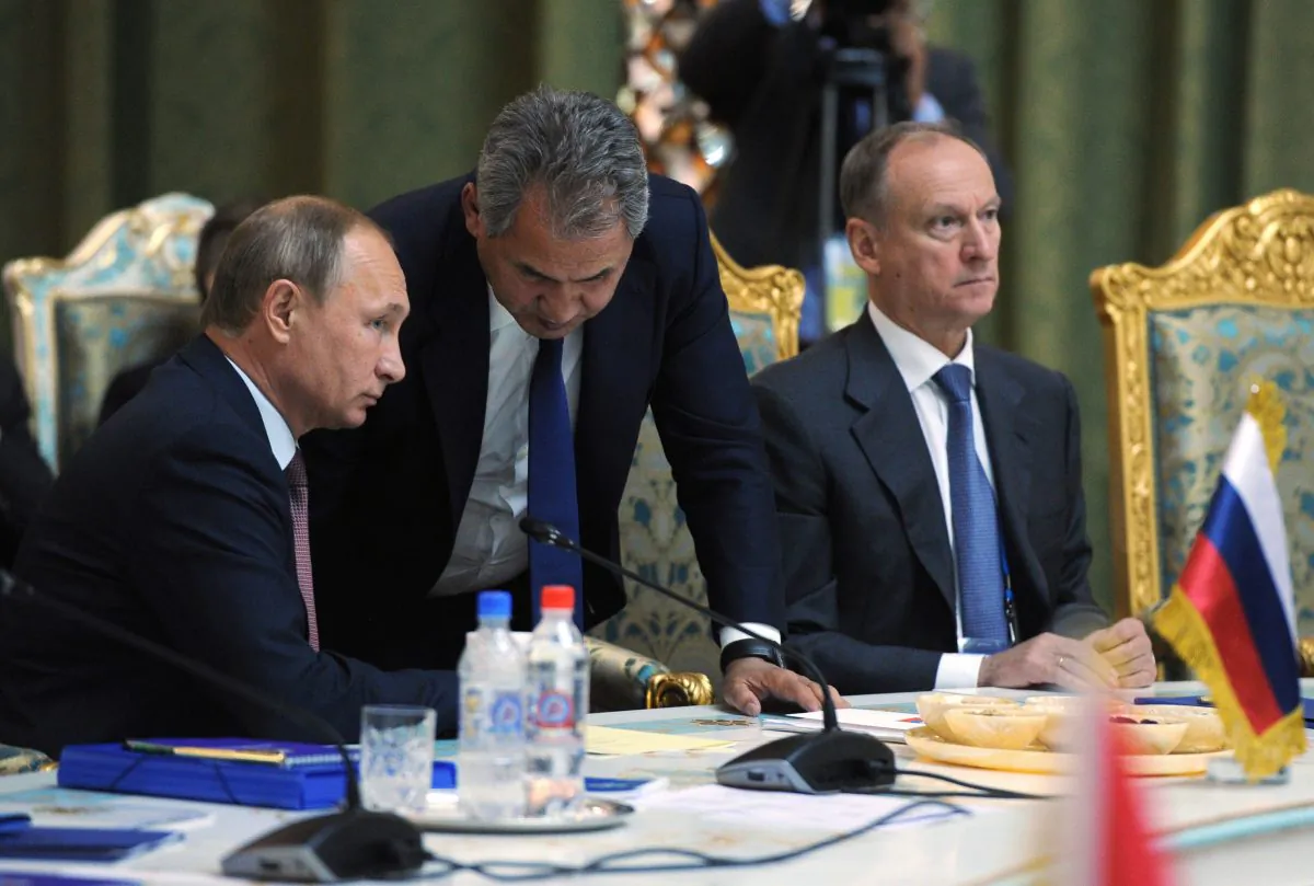 Russian President Vladimir Putin listens to Russia's Defense Minister Sergei Shoigu (C) at the meeting of the Collective Security Treaty Organization (CSTO) in Dushanbe, Tajikistan, on Sept. 15, 2015. (Mikhail Klimentyev/RIA-Novosti via AP)