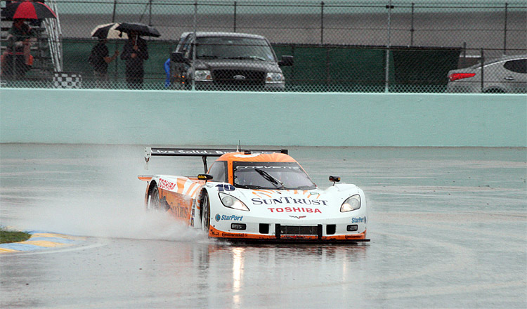 1AA339SunTrustRainMiami2012WEB The No. 10 SunTrust Dallara-Corvette kicks up a wave as it passes through puddles on Homestead-Miami Speedway during the Rolex Grand Prix of Miami. (Chris Jasurek/The Epoch Times)