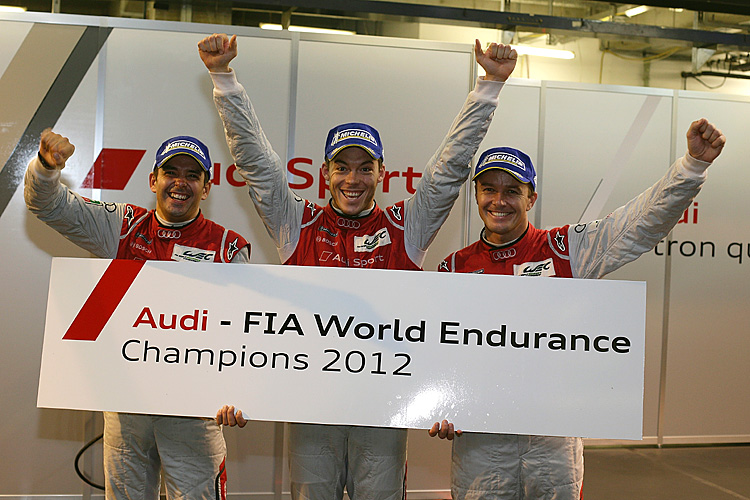 Benoît Tréluyer, André Lotterer, and Marcel Fässler celebrate winning the 2012 WEC drivers' championship. (Audi Motorsport)