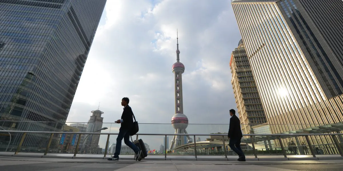 Pedestrians walk through the financial district of Shanghai on Oct. 16, 2013. (Peter Parks/AFP/Getty Images)