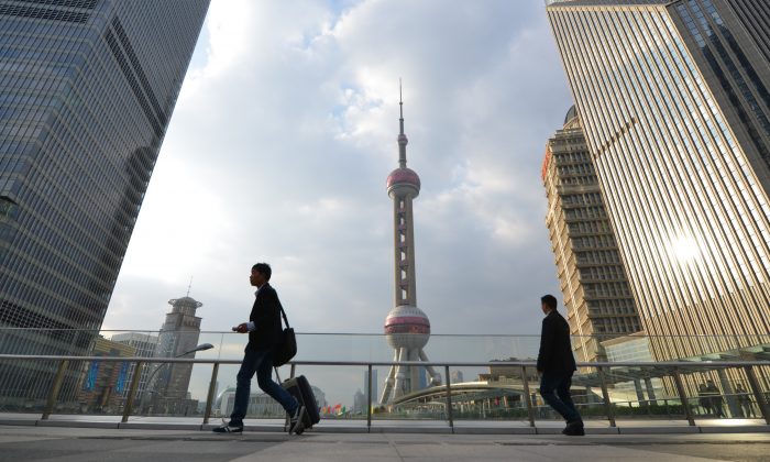 Pedestrians walk through the financial district of Shanghai on Oct. 16, 2013. (Peter Parks/AFP/Getty Images)