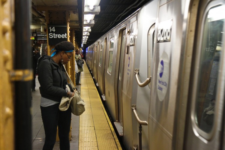 People wait for the R train on the Union Square subway stop in New York last December. People wait for the R train on the Union Square subway stop in New York last December.