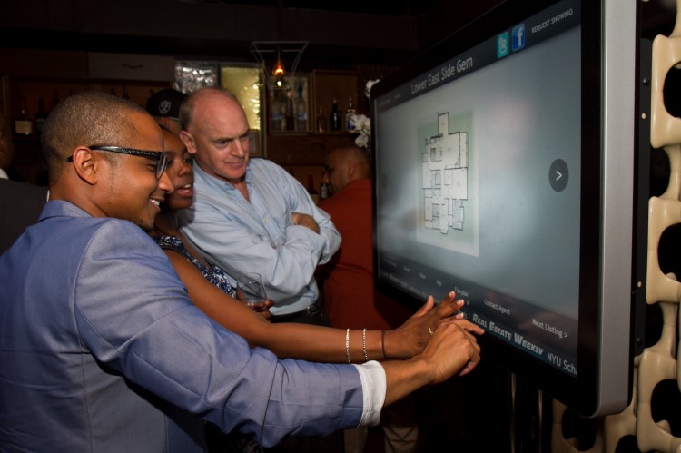 20120628_LOH real Estate _Chasteen_IMG_8367 Vernon Jones, CEO of LOH, demonstrates to guests his company's new interactive touch screen on June 28. The touch screen is designed for real estate companies or brokers to install in storefront windows in the Lower East Side of Manhattan. (Benjamin Chasteen/The Epoch Times)