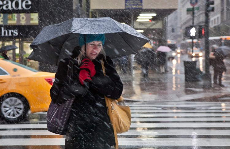 A woman takes shelter under her umbrella during the nor'easter storm in New York on Wednesday, Nov. 7. (Amal Chen/The Epoch Times)