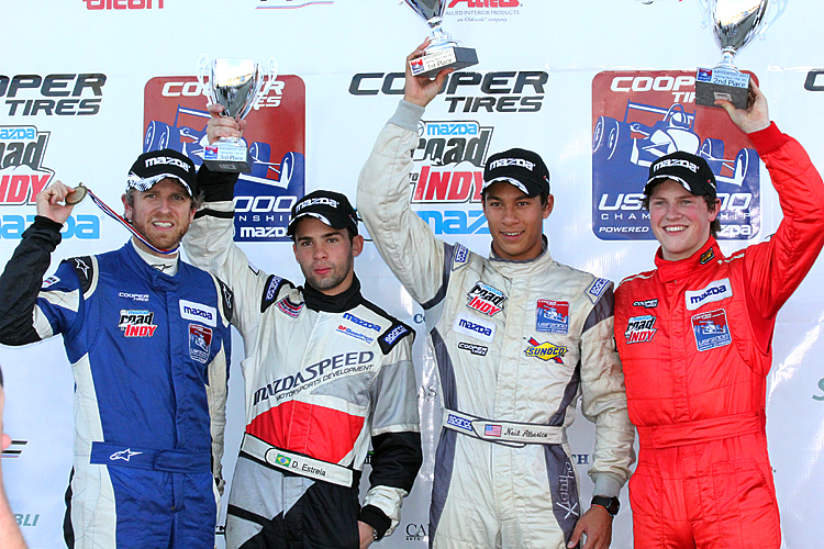 Stefan Rzadzinski, Danilo Estrela, Neil Alberico, and Scott Hargrove celebrate success in the USF2000 season opener at Winterfest at Sebring International Raceway. (James Fish/The Epoch Times)