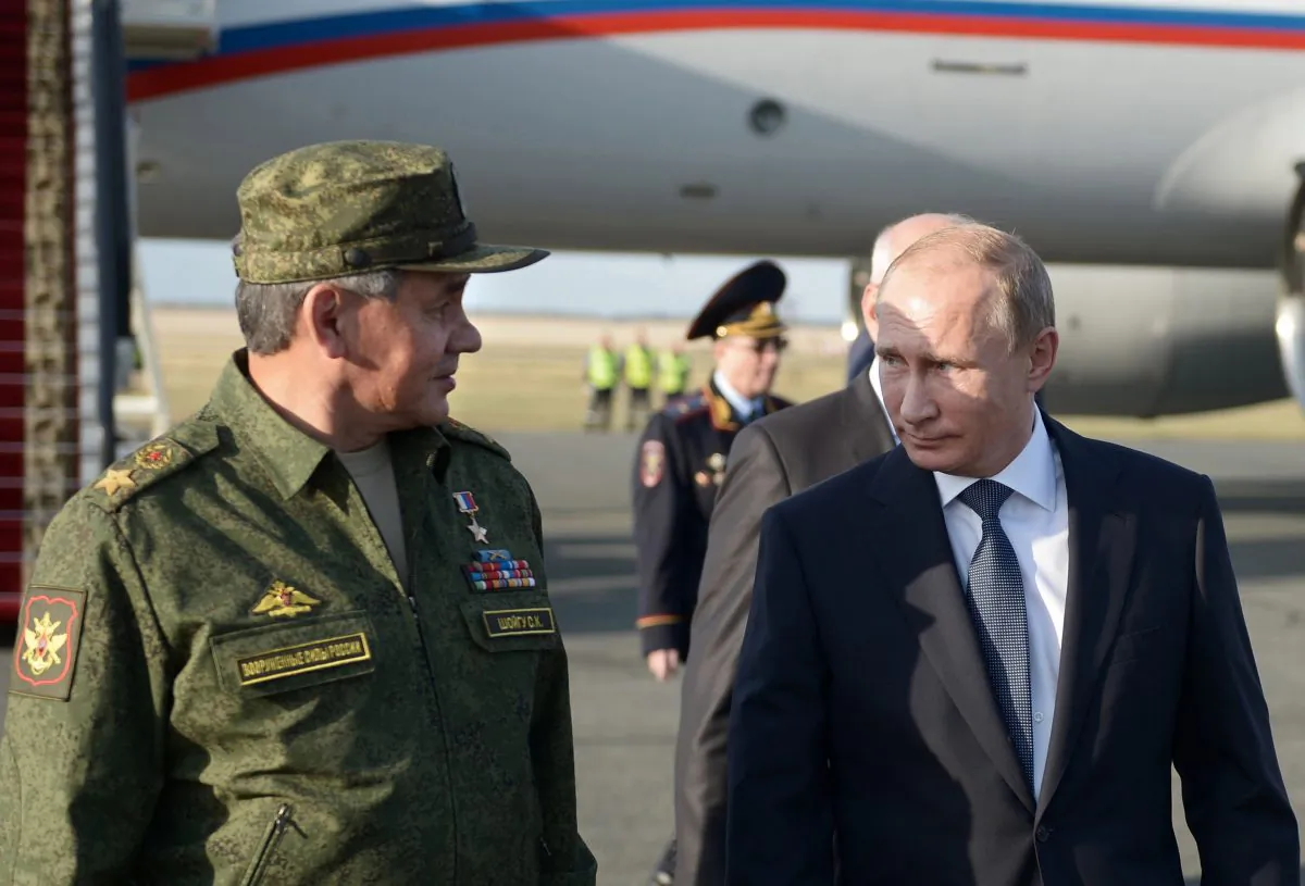 Russian President Vladimir Putin speaks with Defense Minister Sergei Shoigu on his arrival in Orenburg region, about 800 miles southeast of Moscow, Russia, on Sept. 19, 2015. (Alexei Nikolsky/RIA-Novosti via AP)