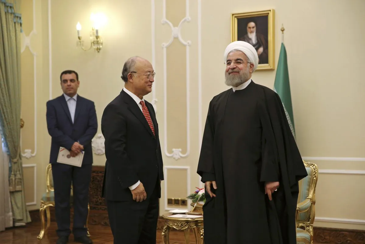 Iranian President Hassan Rouhani, right, welcomes U.N. nuclear chief Yukiya Amano for their meeting in Tehran, Iran, Sunday, Sept. 20, 2015. (AP Photo/Vahid Salemi)