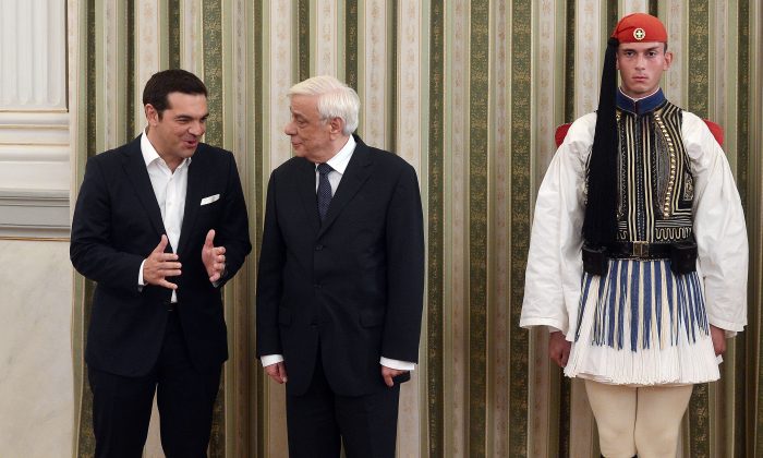 Newly elected Greek Prime Minister Alexis Tsipras (L) speaks with Greece's President Prokopis Pavlopoulos after the oath-taking ceremony, at the presidental palace in Athens, on Sept. 21, 2015.(Louisa Gouliamaki/AFP/Getty Images)