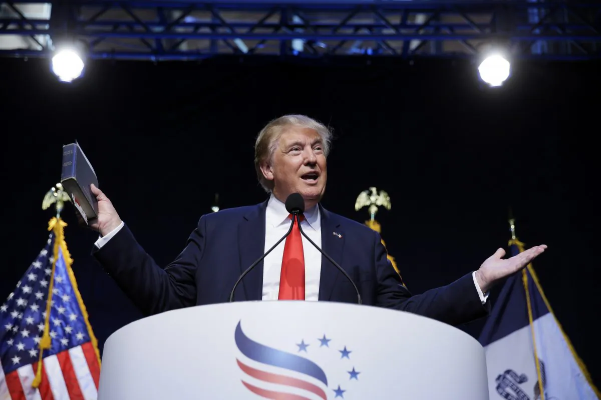 Republican presidential candidate, businessman Donald Trump holds a Bible as he speaks during the Iowa Faith & Freedom Coalition's annual fall dinner, Saturday, Sept. 19, 2015, in Des Moines, Iowa. (AP Photo/Charlie Neibergall)