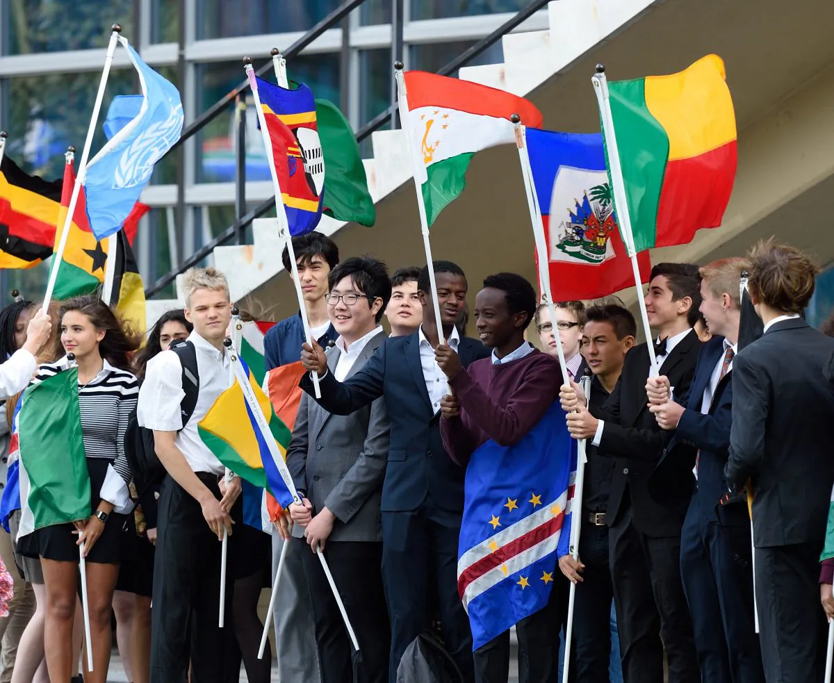 School children hold the flags of nations during the Peace Bell Ceremony to commemorate the International Day of Peace September 21, 2015 at the United Nations in New York. AFP PHOTO/DON EMMERT        (Photo credit should read DON EMMERT/AFP/Getty Images)