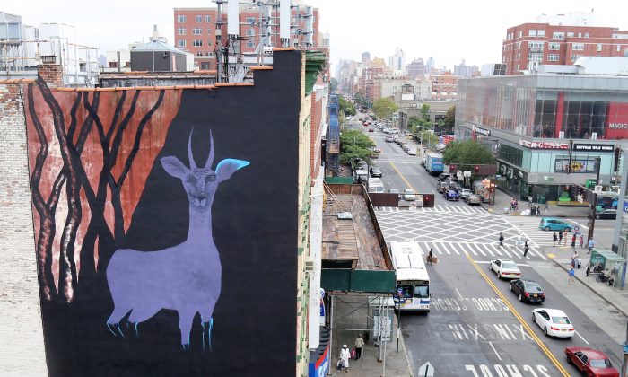 In this Sept. 10, 2015 photo, a large gazelle mural is shown on the side of a building in the Harlem neighborhood of New York. (AP Photo/Mike Balsamo)