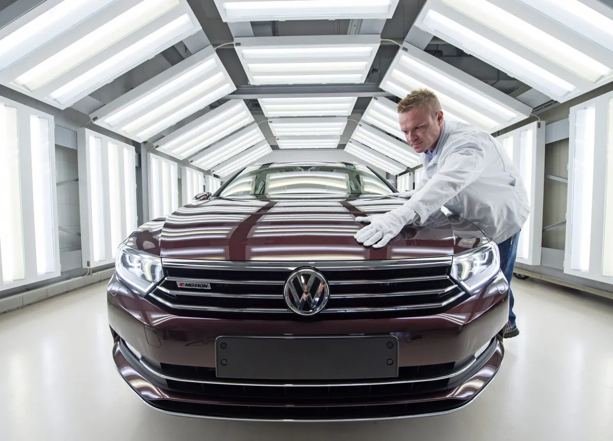 In this Jan 26, 2015 file photo worker Maik Neubert checks a Passat Variant car during the visual inspection during a press tour at the plant of the German manufacturer Volkswagen Sachsen in Zwickau, Germany. (AP Photo/Jens Meyer)