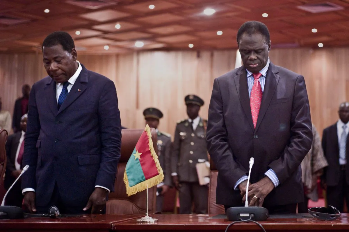 Burkina Faso's transitional president Michel Kafando (R) stands alonsgide Benin President Thomas Boni Yayi (L) during a official handover ceremony in Ouagadougou, Burkina Faso, Wednesday, Sept. 23, 2015. (AP Photo)
