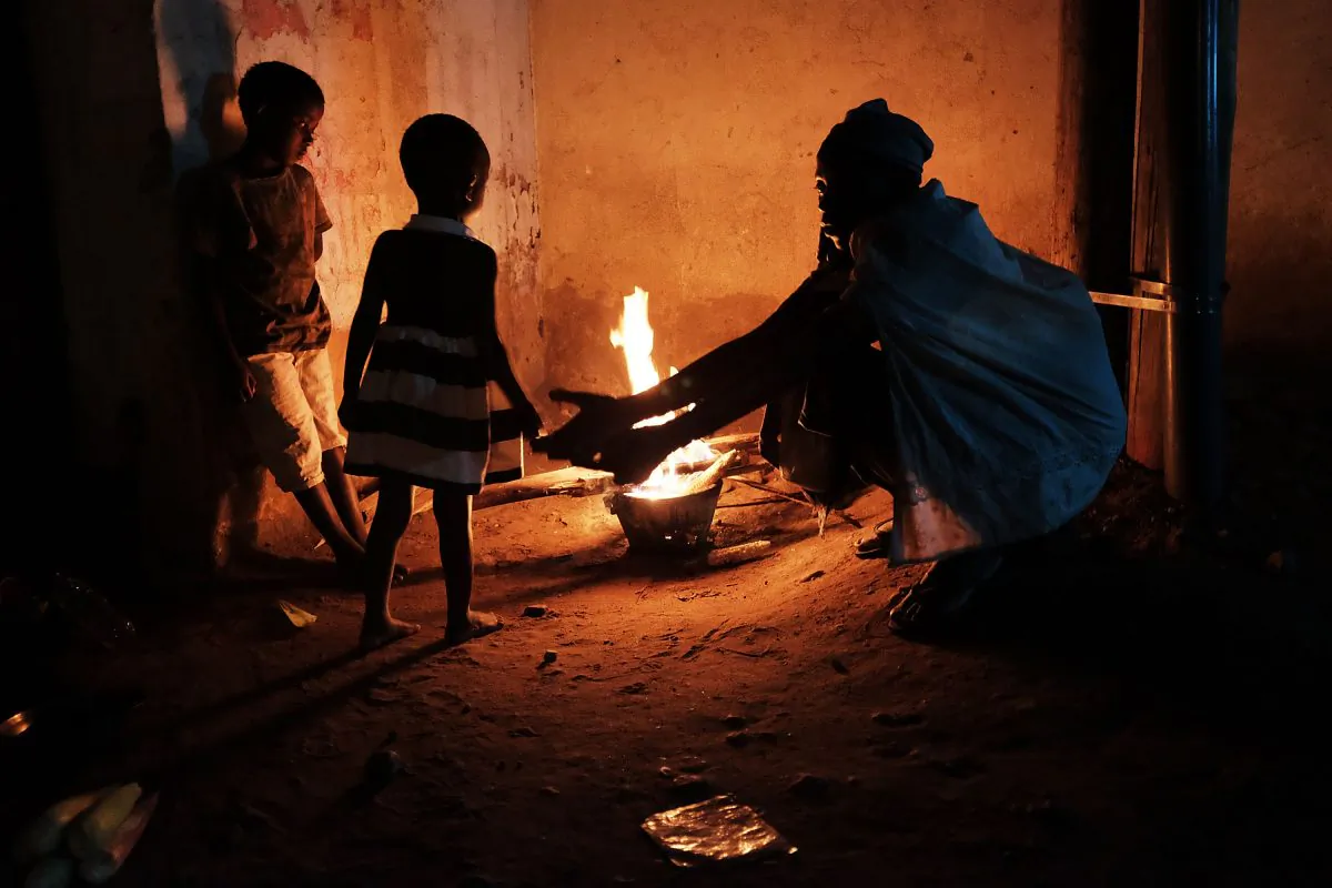 A homeless family cooks their dinner on an open fire in the street of Bujumbura, Burundi, on June 28, 2015. (Spencer Platt/Getty Images)