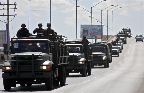 Members of Mexican Army arrive to Ciudad Juárez in northern Mexico, on March 13, 2009. Mexican President Felipe Calderon has acknowledged the country's drug war is bloodier and tougher than he thought when he first took office in 2006, but vowed to eradicate the 'cancer' that is consuming Mexico and has ordered the deployment of an additional 5,000 military troops and 1,000 policemen to the drug-ravaged northern border with the United States. (Jesus Alcazar/AFP/Getty Images)
