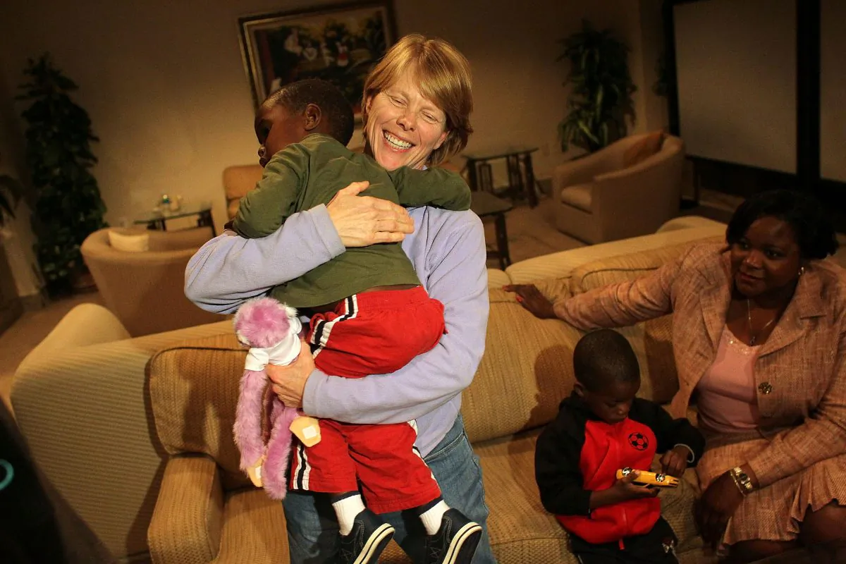 A foster mother holds her adoptive son in Miami, Fla., on Feb. 1, 2010. (Photo: Joe Raedle/Getty Images)