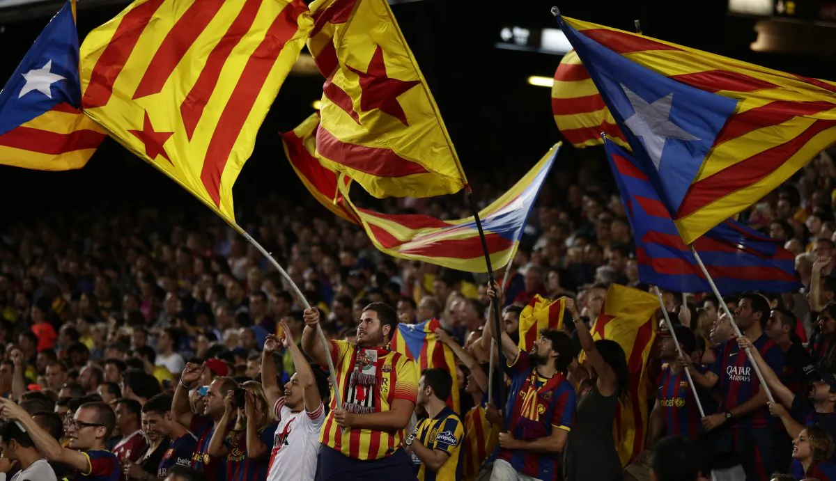 In this photo taken Sunday, Sept. 20, 2015, FC Barcelona's supporters hold "estelada flags, that symbolise Catalonia's independence, during a Spanish La Liga soccer match between FC Barcelona and Levante at the Camp Nou stadium in Barcelona, Spain. (AP Photo/Manu Fernandez)