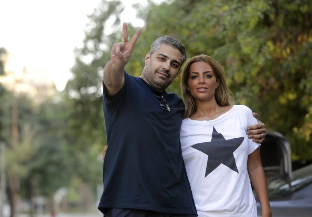 A triumphant Mohamed Fahmy poses with his wife Marwa Omara after being released from prison in Cairo, Egypt, on Sept. 23, 2015. Fahmy and his colleague Baher Mohammed were among a group of 100 people pardoned by Egyptian President Abdel-Fattah el-Sissi. (AP Photo/Amr Nabil)