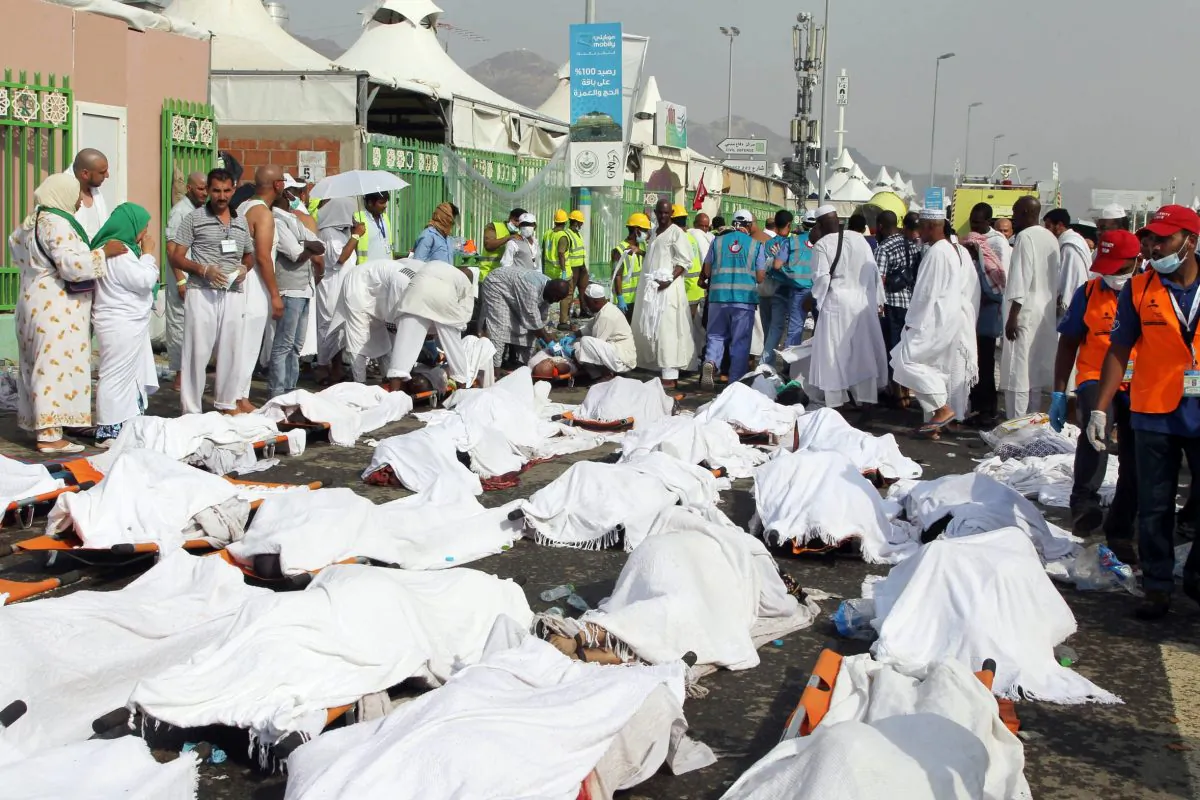Saudi emergency personnel stand near bodies of Hajj pilgrims at the site where at least 717 were killed and hundreds wounded in a stampede in Mina, near the holy city of Mecca, at the annual hajj in Saudi Arabia on September 24, 2015. (STR/AFP/Getty Images)