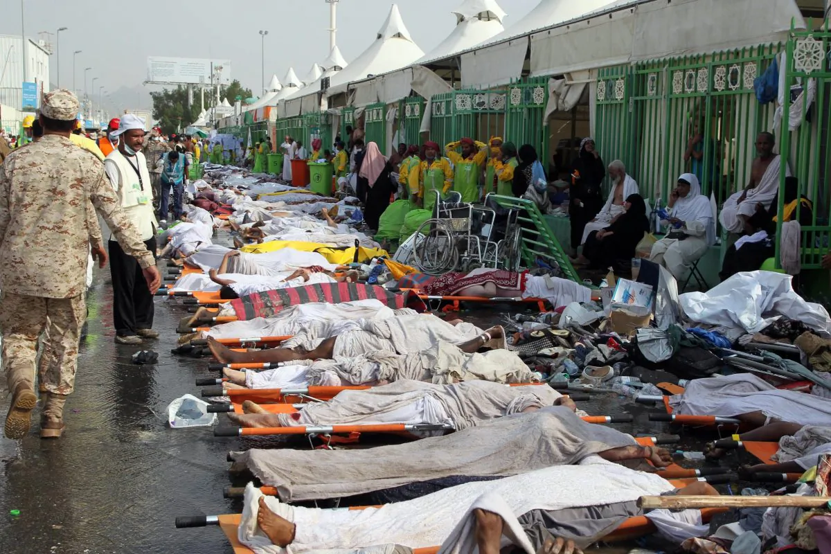 Saudi emergency personnel stand near bodies of Hajj pilgrims at the site where at least 717 were killed and hundreds wounded in a stampede in Mina, near the holy city of Mecca, at the annual hajj in Saudi Arabia on Sept 24. (STR/AFP/Getty Images)