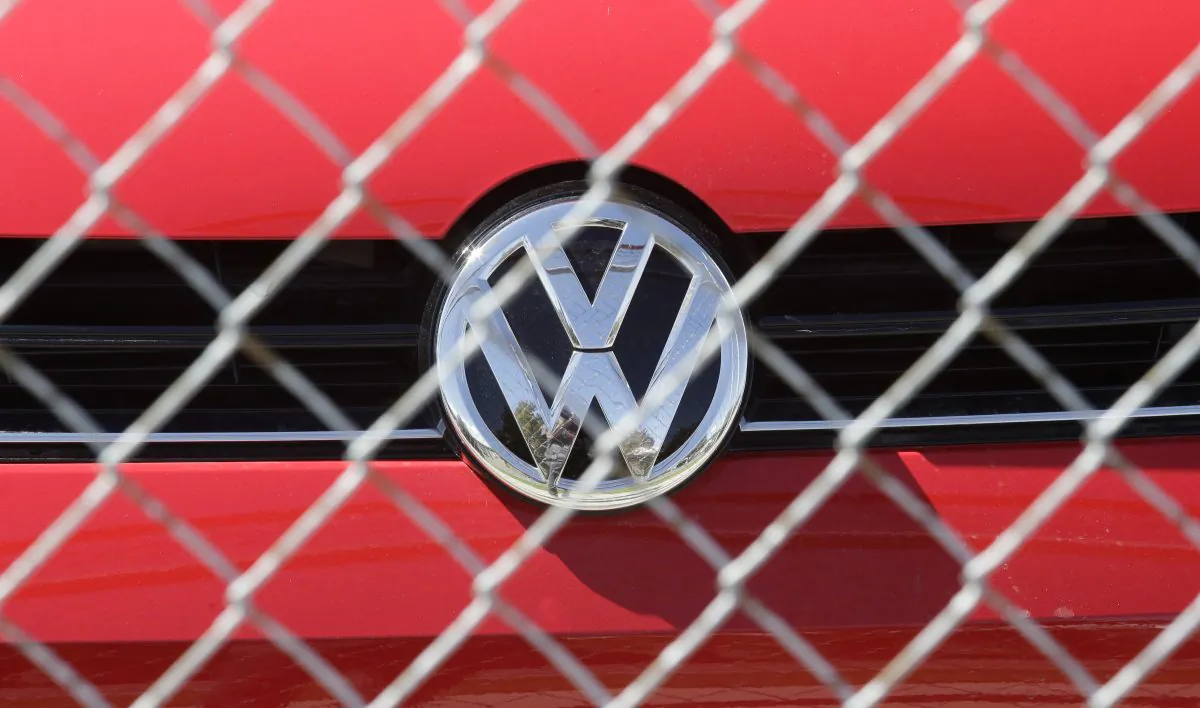 A Volkswagen diesel sits behind a security fence on a storage lot near a VW dealership in Salt Lake City, on Sept. 23, 2015. (Rick Bowmer/AP Photo)