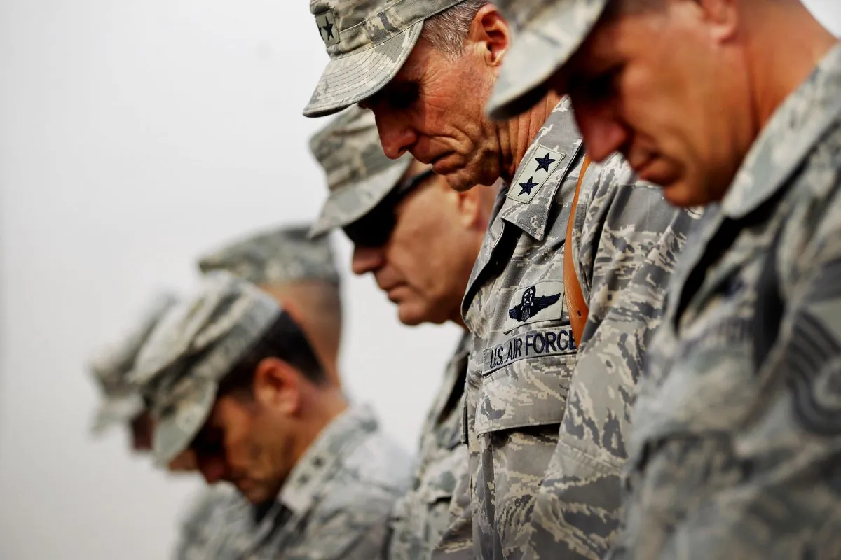 U.S. military personnel bow their heads in prayer during a casing ceremony for the departure of U.S. troops from Iraq at the former Sather Air Base, in Baghdad, Iraq, on Dec. 15, 2011. (Mario Tama/Getty Images)