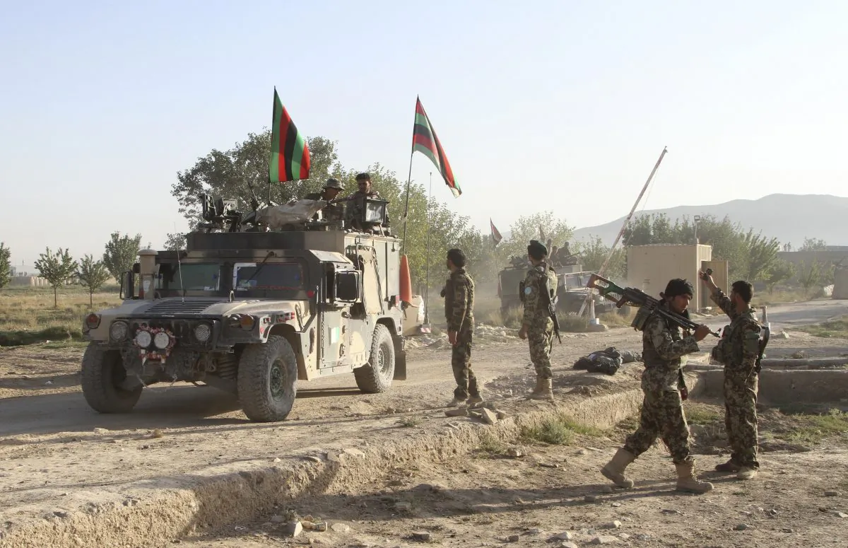 Afghan national army stand guard near the dead body of a Taliban attacker in front of the main prison building after an attack in Ghazni province, eastern Afghanistan, Monday, Sept. 14, 2015. (AP Photo/Rahmatullah Nikzad)
