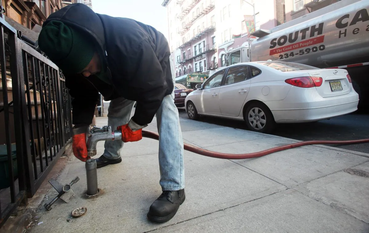 Stephen St. Clair of South Carolina Heating Fuel delivers heating oil to a building in Harlem, N.Y., on Jan. 12, 2010. (Mario Tama/Getty Images)