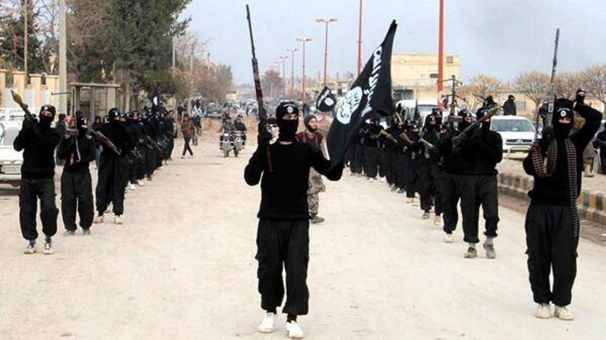 ISIS extremists parade down a street in Raqqa, Syria, on Jan. 14, 2014. (ISIS Website via AP)