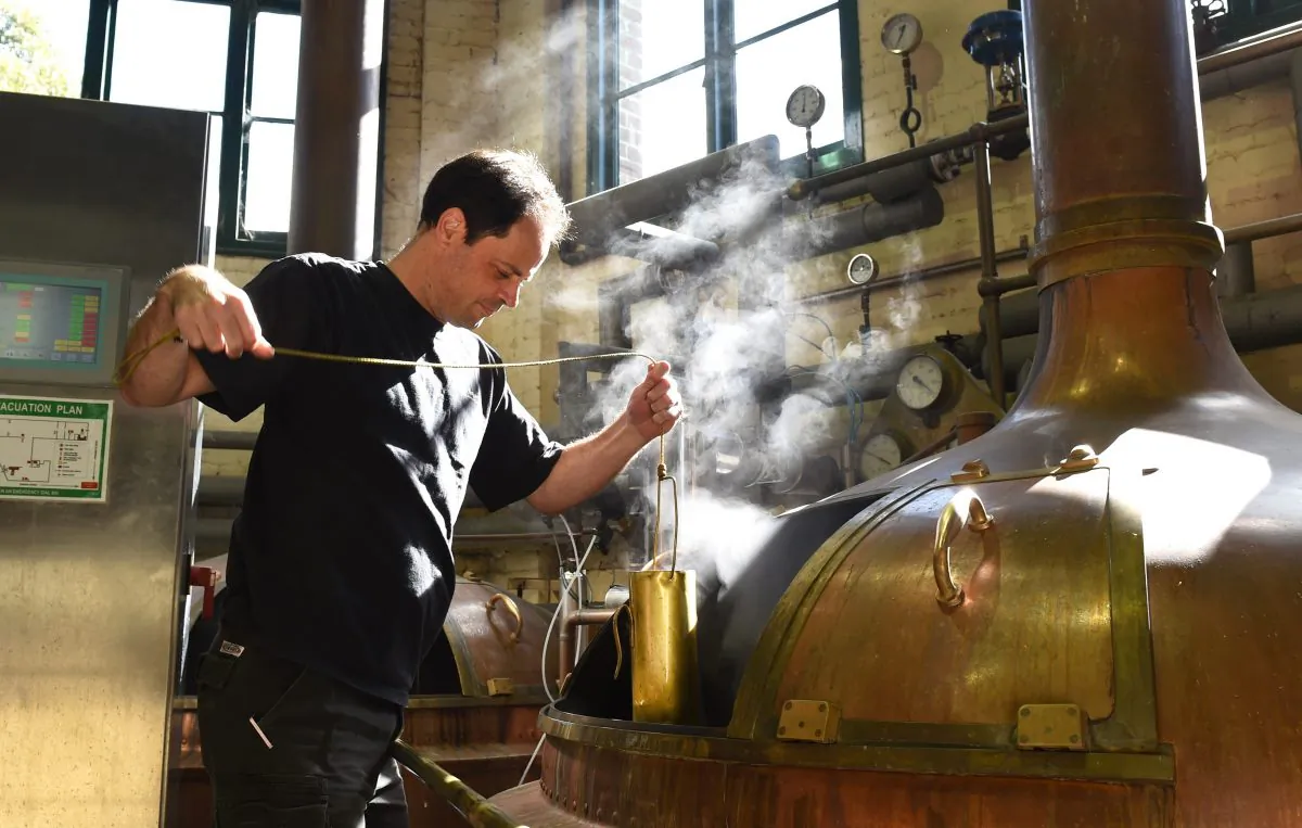 Brewer Peter Merrington taking a sample of wort from a German copper brewing kettle at the Malt Shovel Brewery in Sydney where the popular boutique beer label James Squire is produced, on Sept. 3, 2014. The changing beer tastes of Australians, known for their love of a "cold one," mean they are now looking to embrace more diverse flavours in their brews from beetroot to liquorice, says brewmaster Chuck Hahn. (William West/AFP/Getty Images)