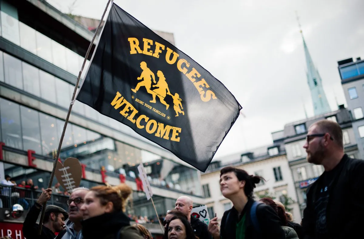 People take part in a demonstration in solidarity with migrants seeking asylum in Europe after fleeing their home countries, in Stockholm, on Sept. 12, 2015. (Jonathan Nackstrand/AFP/Getty Images)
