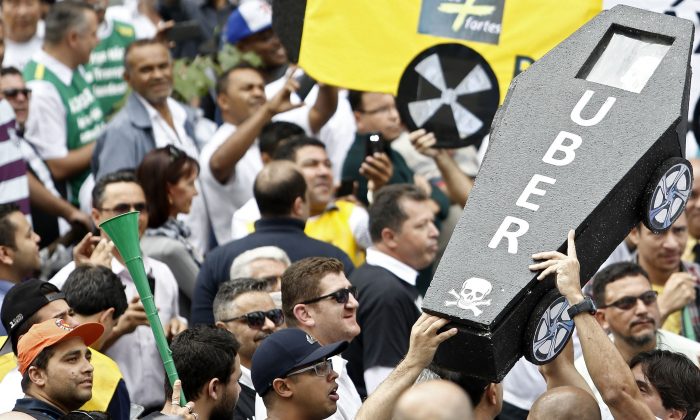 Taxi drivers demonstrate outside the chamber of deputies in the neighborhood of Se, Sao Paulo, Brazil, on September 9, 2015. (Miguel Schincariol/AFP/Getty Images)