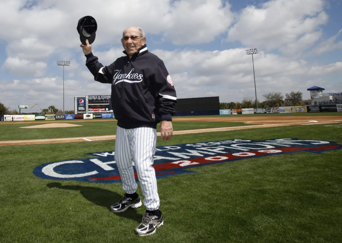 New York Yankees Hall of Fame catcher Yogi Berra tips his cap as he is introduced during pregame ceremonies prior to the Yankees home opener spring training baseball game against the Pittsburgh Pirates at Steinbrenner Field in Tampa, Fla., Wednesday, March 3, 2010. (AP Photo/Kathy Willens)